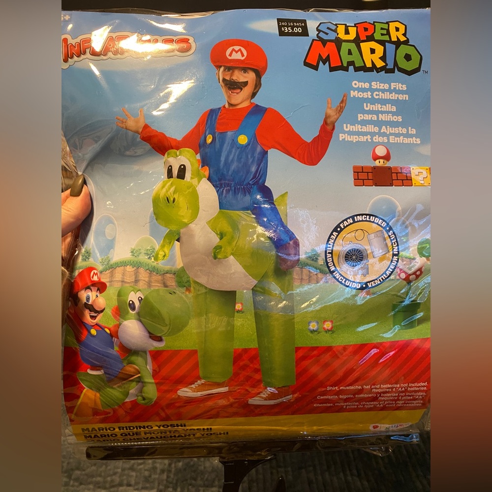 Super Mario. Mario riding Yoshi inflatable.